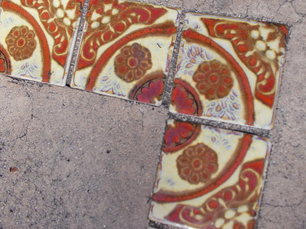 These tiles are embedded in an otherwise plain concrete bench on the east side of the Casa del Prado.