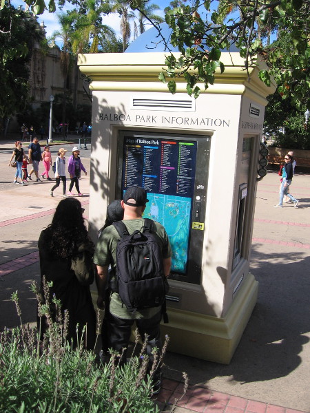 Visitors study a map of enormous Balboa Park at an information kiosk.