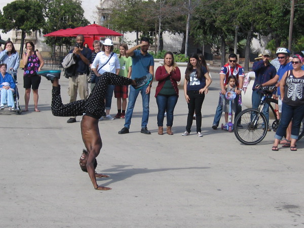 An athletic street performer wows the crowd with amazing moves in the Plaza de Panama.