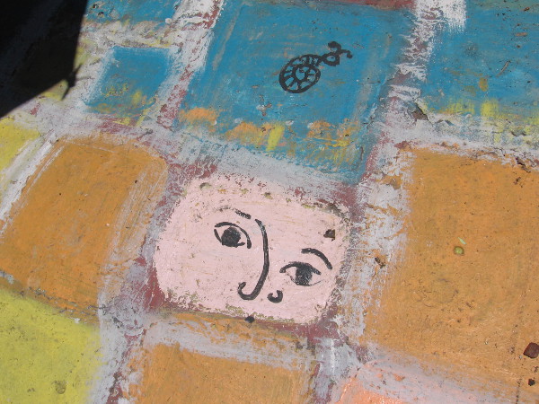Face painted on patio tile in Spanish Village Art Center.