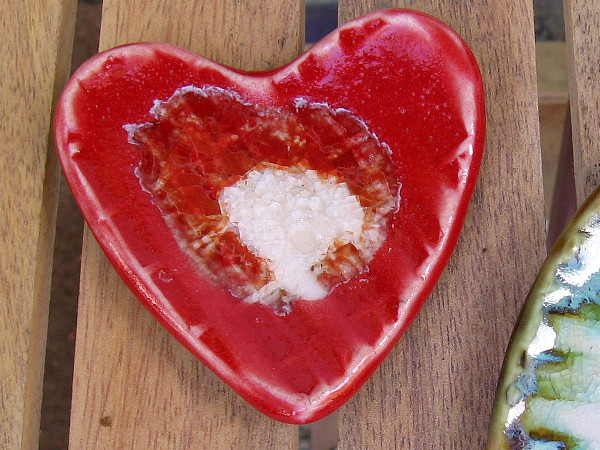 A lustrous red ceramic heart, created by Pierre Bounaud of Studio 40 at Spanish Village Art Center.